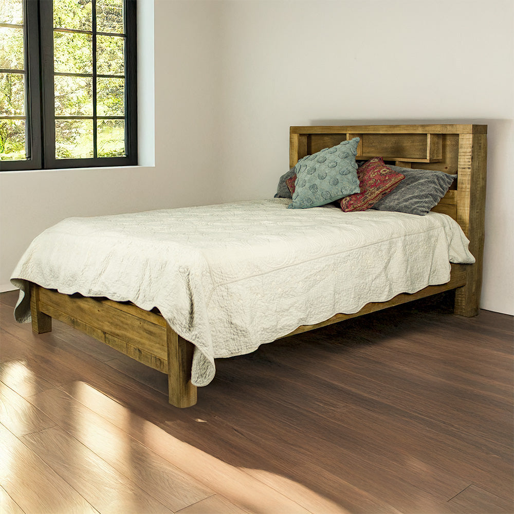 The front of the Amarillo King Slat Bed Frame, dressed in bed sheets and pillows, inside of a warm, modern bedroom.