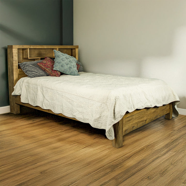 The front of the Amarillo Queen Slat Bed Frame, dressed in bed sheets and pillows, in a modern bedroom.