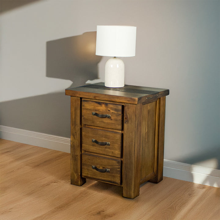 The front of the Botanica Bedside Cabinet. There is a lamp on top.
