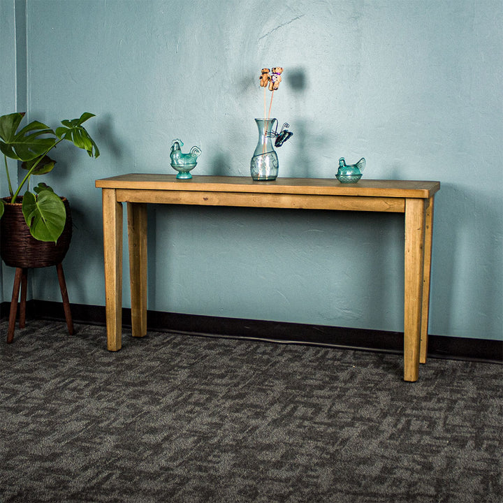 Front of the Cairns Recycled Pine Hall Table. There are two blue glass ornaments and a blue glass vase on top.