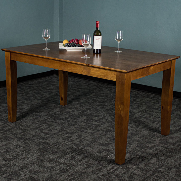 An overall view of the Hamilton Rimu Stained Dining Table (1500mm). There is a platter of fruit on top, three wine glasses and a bottle of wine on top.