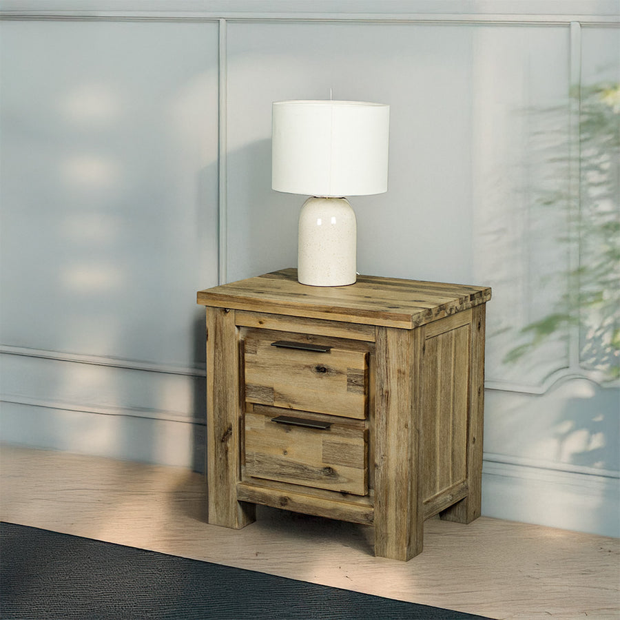 The front of the Mars Two-Drawer Bedside Cabinet with a lamp on top.