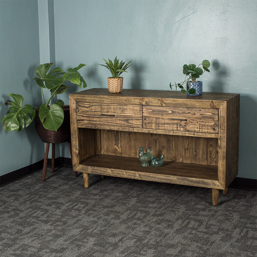 Paddington Recycled Pine Buffet / Hall Table front view. There are two potted plants on the top and two glass ornaments on the lower shelf.