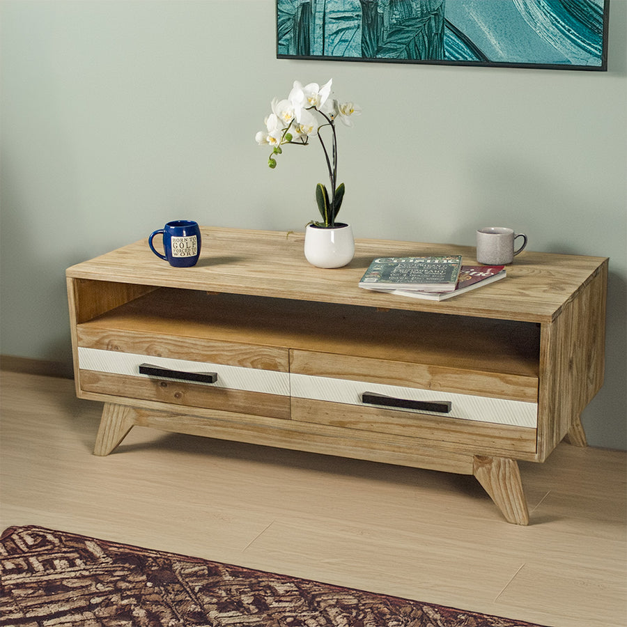 The front of the Soho 4 Drawer NZ Pine Coffee Table. There are two coffee mugs, two magazines and a pot of white flowers on top.