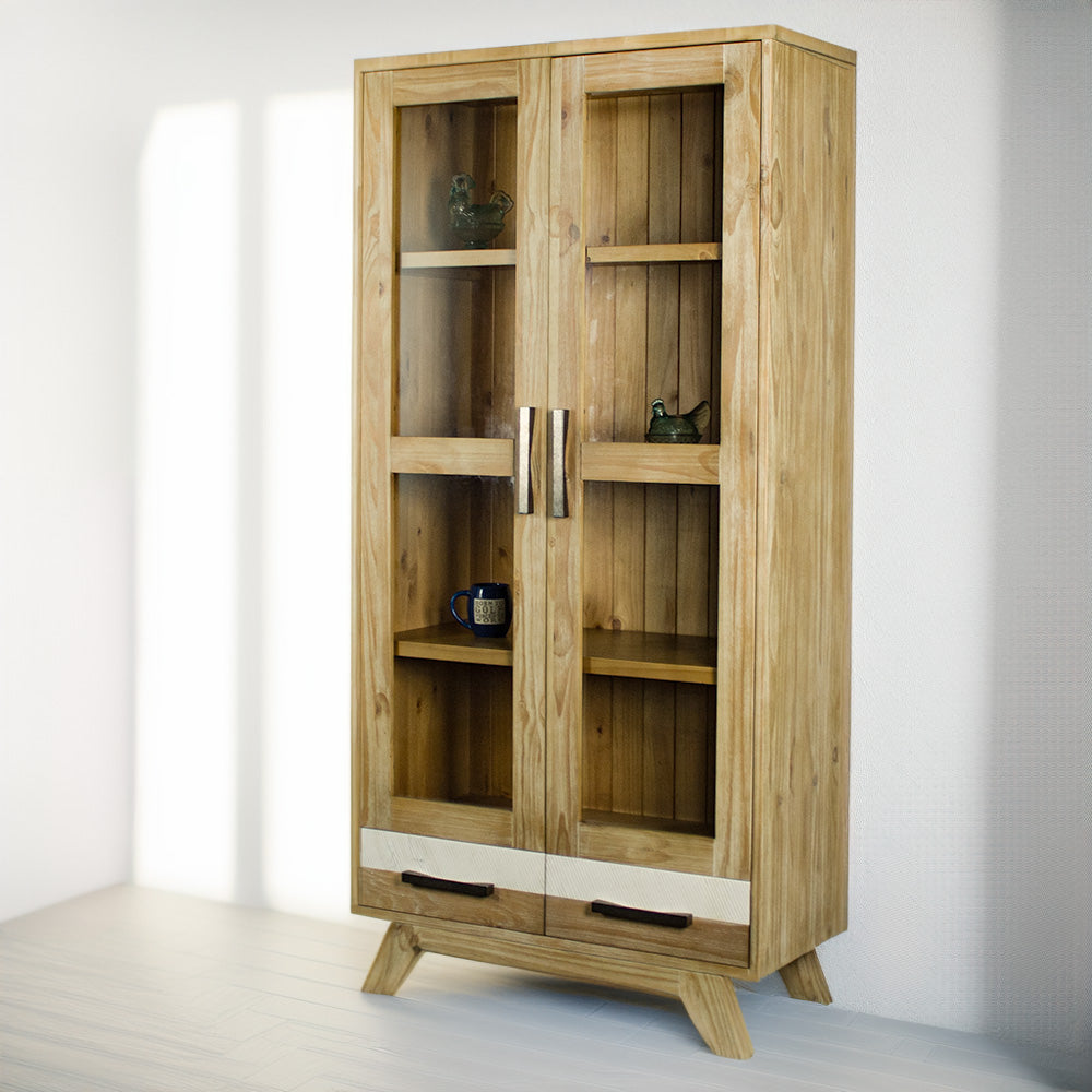 The front of the Soho NZ Pine Display Cabinet. There is a glass ornament on the top two shelves and a coffee mug on the lower shelf.