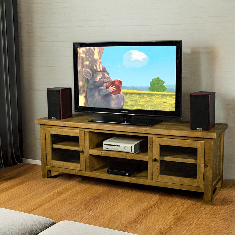 An overall view of the Ventura Recycled Pine Medium TV Unit. There is a TV on top, with two bookcase speakers on either side and a DVD player on the top shelf in the middle of the unit.