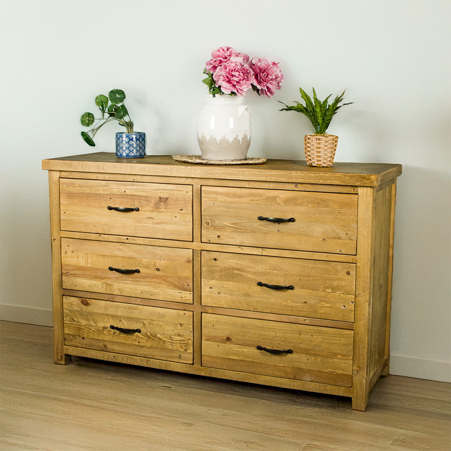 The front of the Ventura Recycled Pine Lowboy. There are three potted plants on top.