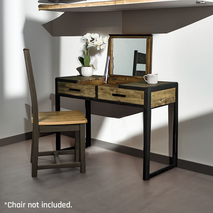 The front of the Victor Dressing Table / Desk. There is a pot of white flowers and a coffee mug on top. There is a chair in front of the desk.