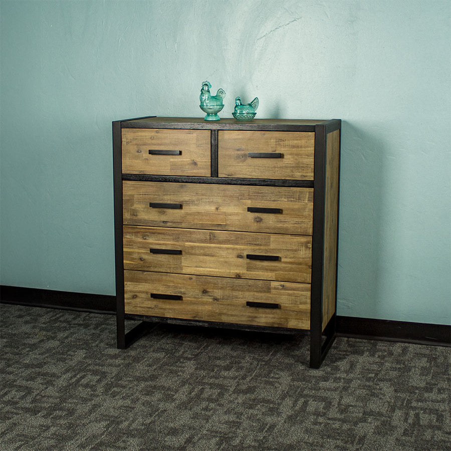 Front of the Victor 5 Drawer Tallboy. There are two blue glass ornaments on top.