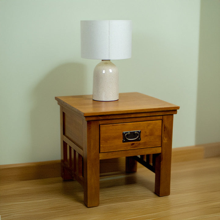 The front of the Montreal Pine Lamp Table, with a lamp on top.
