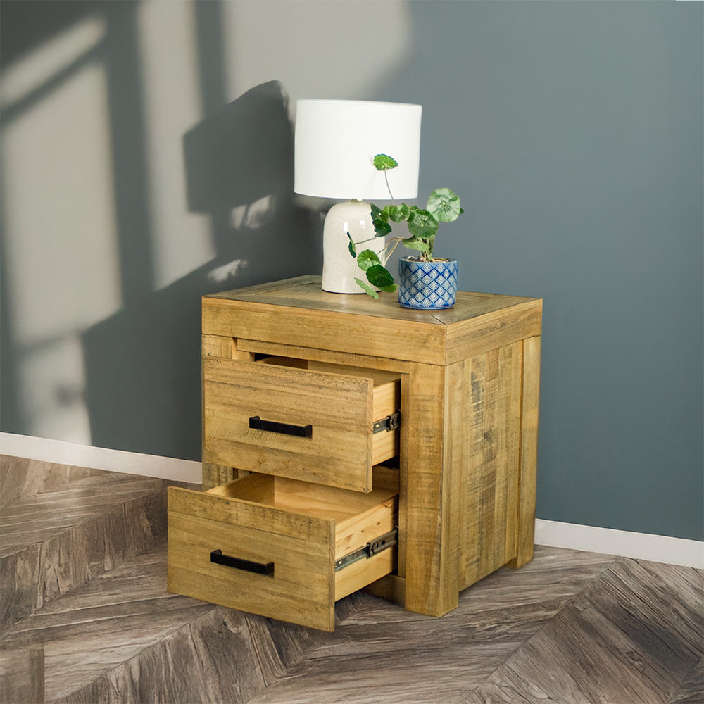 The front of the Amarillo Two Drawer Bedside with its drawers open. There are is a potted plant and a lamp on top.