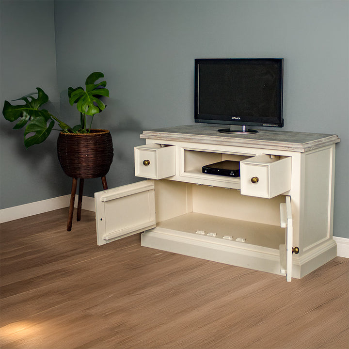 The front of the Biarritz Compact TV Unit with its drawers open. There is a DVD player in the middle shelf and a small TV on top. There is a free standing potted plant next to the unit.