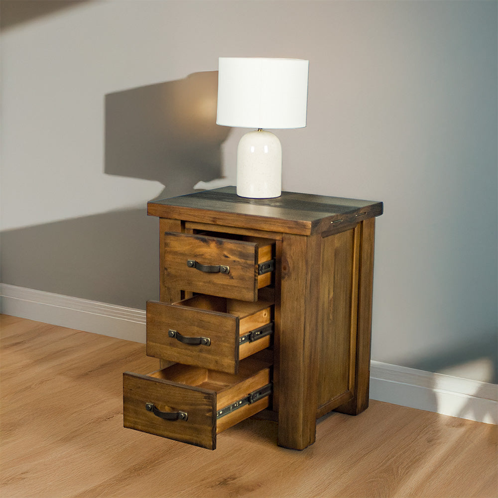 The front of the Botanica Bedside Cabinet, with its drawers open. There is a lamp on top.