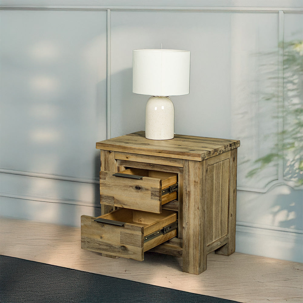 The front of the Mars Two-Drawer Bedside Cabinet with its drawers open. There is a lamp on top.
