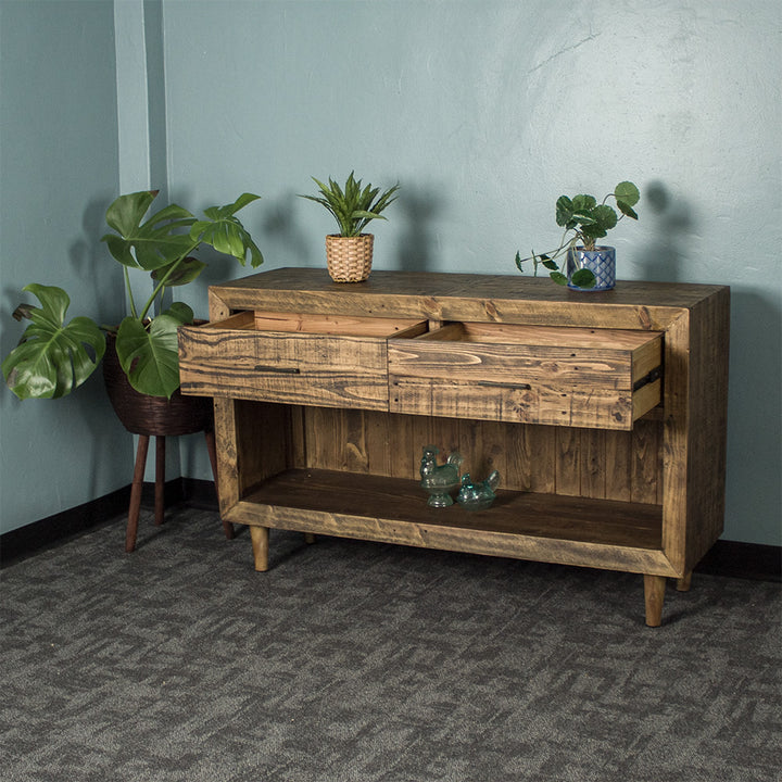 Paddington Recycled Pine Buffet / Hall Table front view with its drawers open. There is two potted plants on top and two blue glass ornaments on the lower shelf.