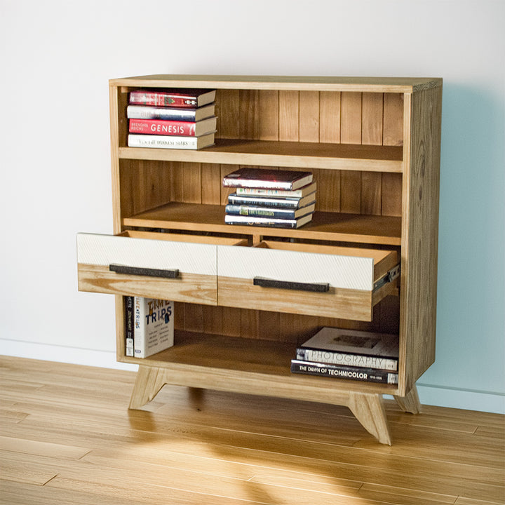 The front of the Soho Short Display Shelf with its two middle drawers open. There are books on each shelf.