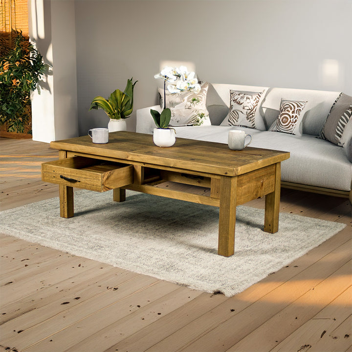 Front view of the Ventura Recycled Pine Coffee Table with its drawers open, both ways. There are two coffee mugs and a pot of white flowers on top.