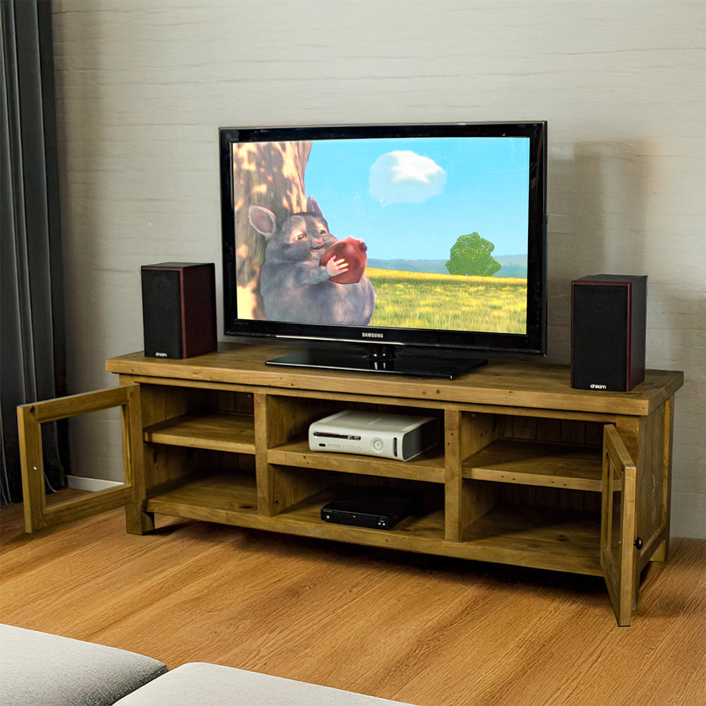 An overall view of the Ventura Recycled Pine Medium TV Unit with its drawers open,. There is a TV on top, with two bookcase speakers on either side and a DVD player on the top shelf in the middle of the unit.