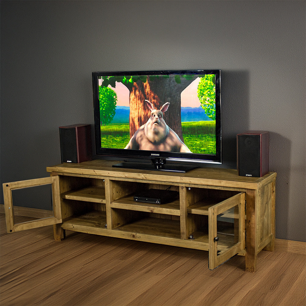 An overall view of the Ventura Recycled Pine Medium TV Unit with its drawers open,. There is a TV on top, with two bookcase speakers on either side and a DVD player on the top shelf in the middle of the unit.