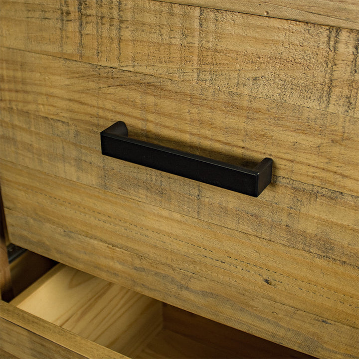 A close up of the black metal handle on the drawers of the Amarillo Seven-Drawer Tallboy.