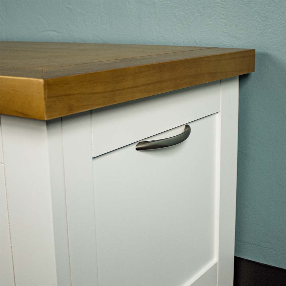 A close up of the curved, silver metal handle on the Felixstowe Pine Blanket Box.