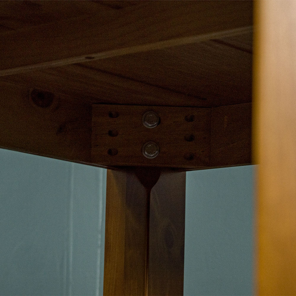 Underneath the Hamilton Square Pine Dining Table (1m), there are two bolts for each leg that secure them to the table.