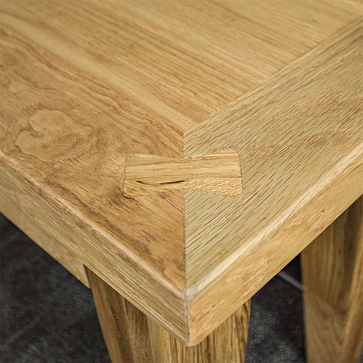 A close up of the top of the Oscar Oak Bench 1.4m showing the wood grain and colour.