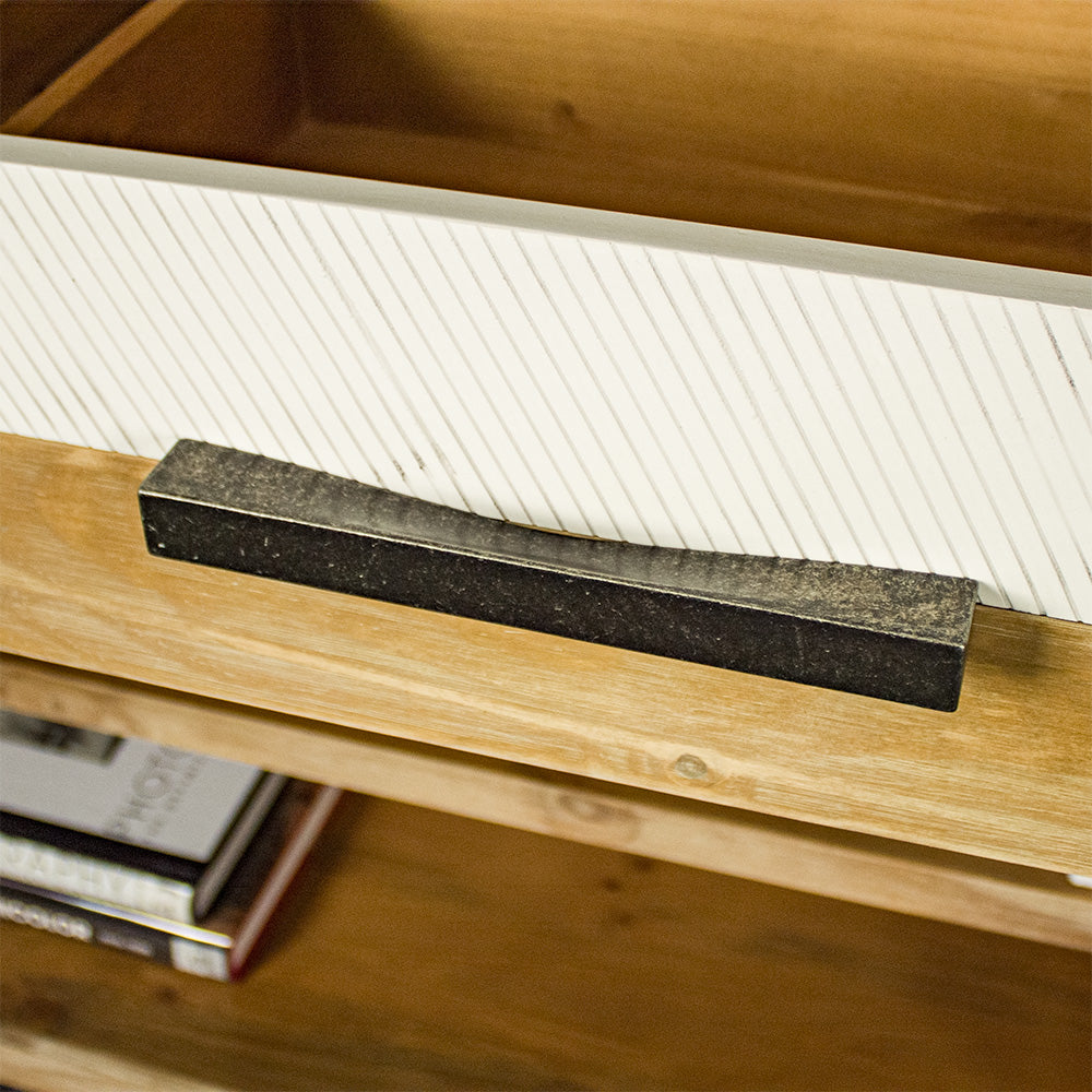 A close up of the brushed black metal handle on the drawers of the Soho Medium Bookcase.