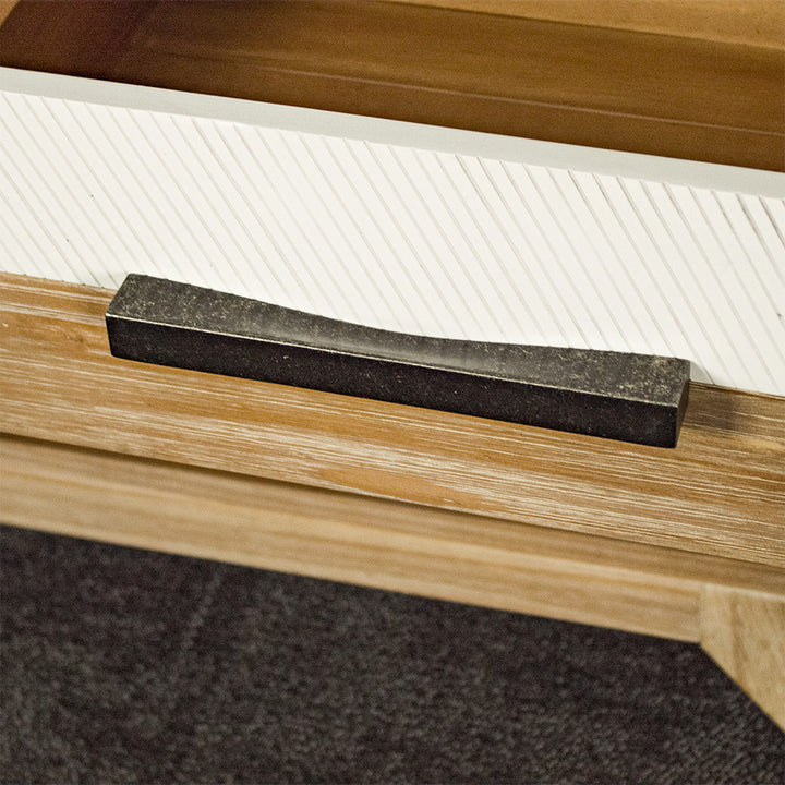 A close up of the brushed black metal handle on the drawer of the Soho Short Display Shelf.