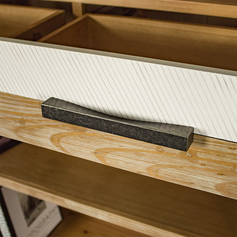 A close up of the brushed black metal handle on the drawers of the Soho Tall Bookcase.