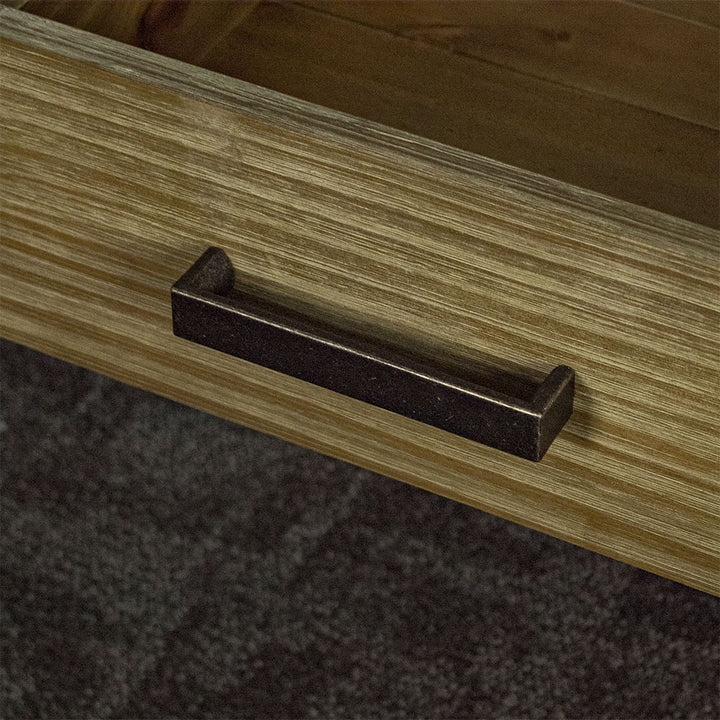 A close up up of the brushed black metal handle on the drawer of the Vancouver 1 Drawer Lamp Table.