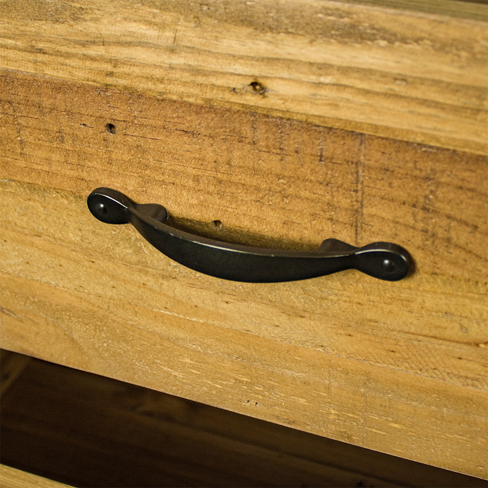 A close up of the black metal handle on the drawers of the Ventura Recycled Pine Lowboy.