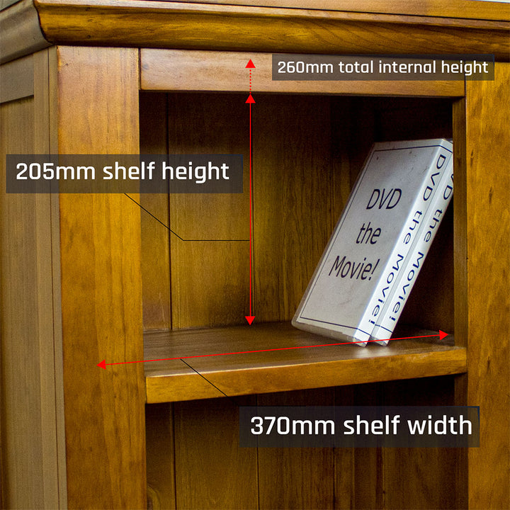 A close up of the top shelf on the Montreal Compact Pine Bookcase. There are two DVD cases on the shelf.