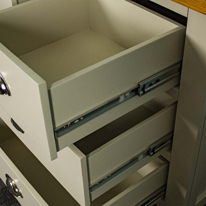 A close up of the smooth metal runners on the drawers of the Alton 7 Drawer Pine Lowboy.