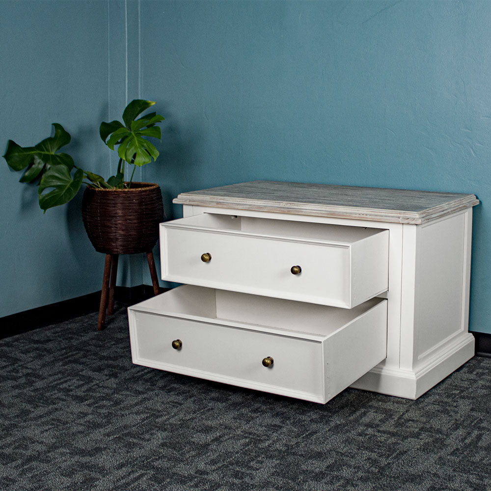 An overall view of the lower half of the Biarritz Two-piece Wardrobe, with its drawers open. There is a free standing potted plant next to it.