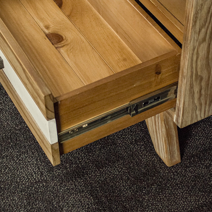 A close up of the smooth metal runners on the drawers of the Soho 4 Drawer NZ Pine Coffee Table.
