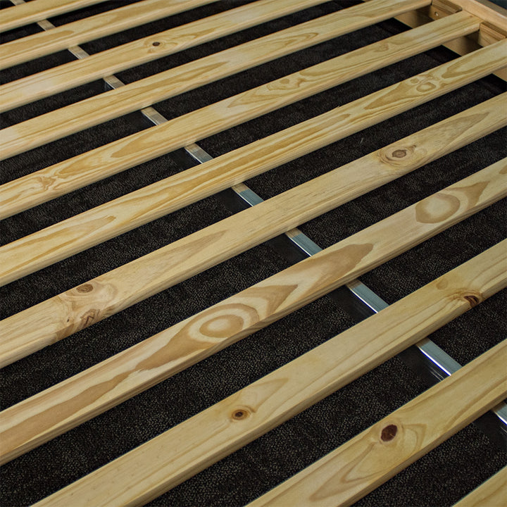 A close view of the slats of the Soho Queen Size Slat Bed Frame with the metal support beam running underneath.