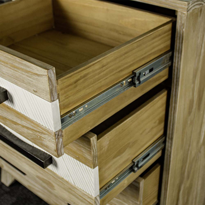 A close up of the smooth metal runners on the drawers of the Soho 5 Drawer Tallboy.