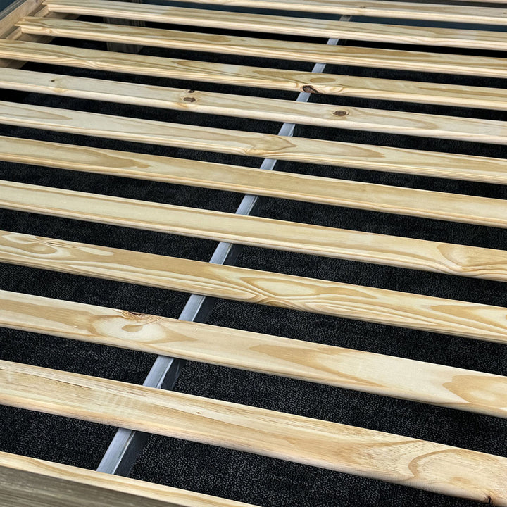 A close view of the slats on the Vancouver King Size Slat Bed Frame, with a metal support bar running underneath.