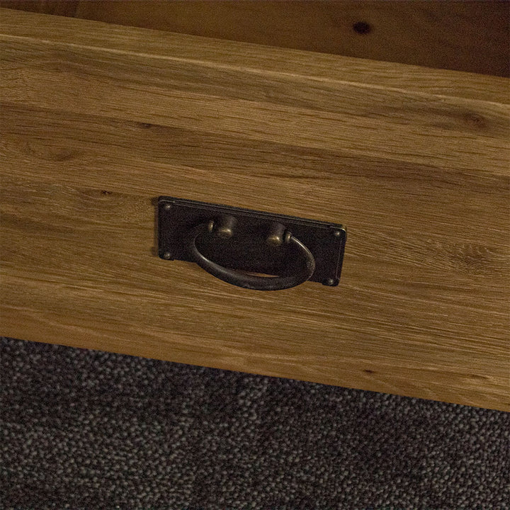 A close up of the swinging metal handle on the drawer of the Yes Compact 1 Door 3 Drawer Oak Buffet.