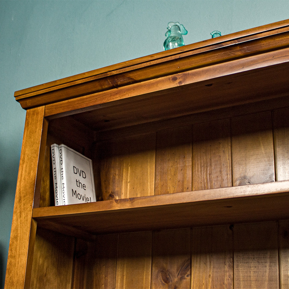 A high angle view of the top shelf of the Montreal Short Pine Bookcase.