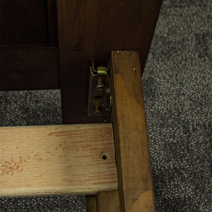 A close up of the bolts that hold the Botanica Queen Slat Bed Frame together.