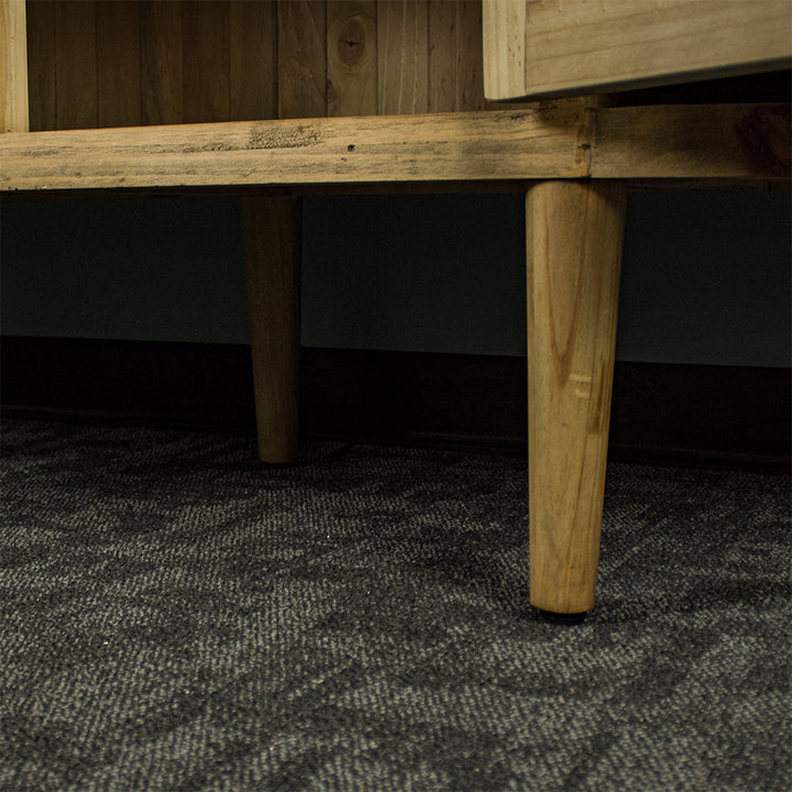 A close up of the legs on the Buffalo Recycled Pine Curved Buffet.