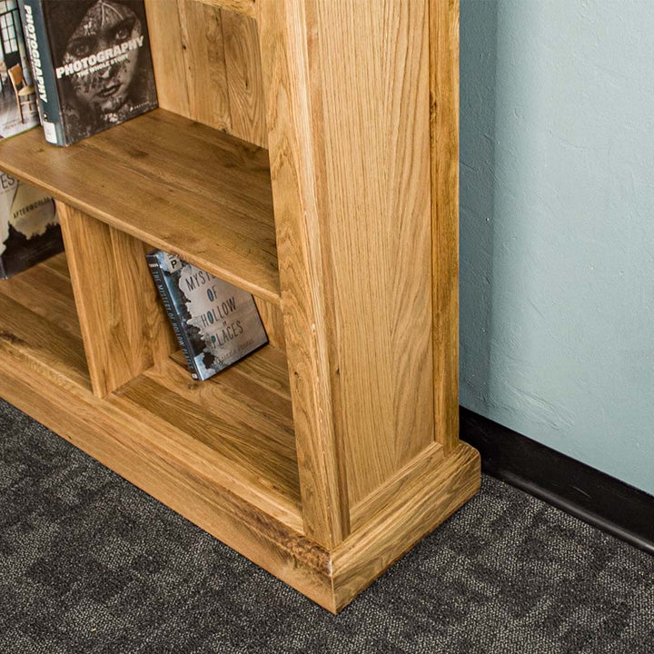 The side of the Versailles Outback Oak Three Level Bookcase.