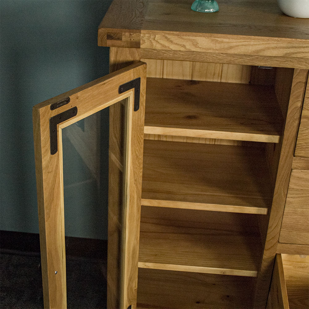 A view of the shelving on the left side of the Yes Compact 1 Door 3 Drawer Oak Buffet.