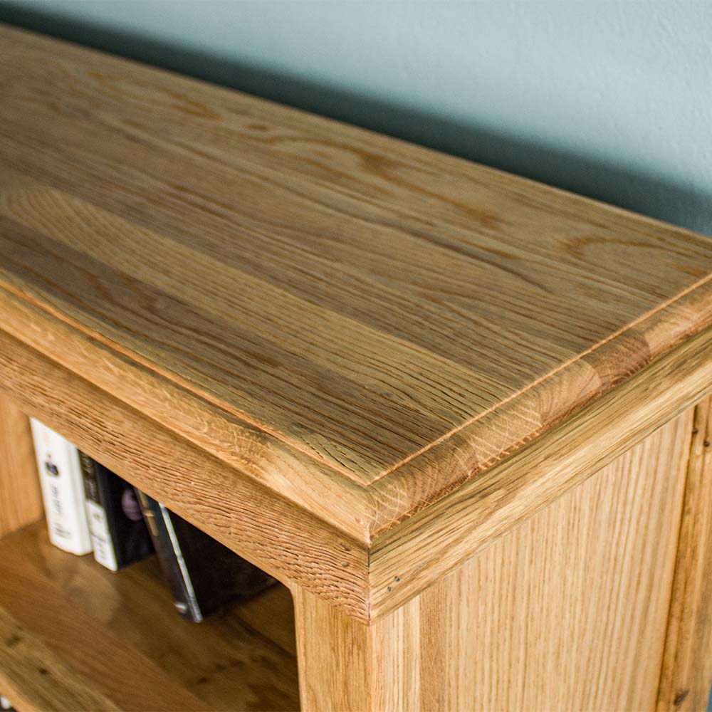 A close up of the top of the Versailles Outback Oak Three Level Bookcase, showing the wood grain and colour.