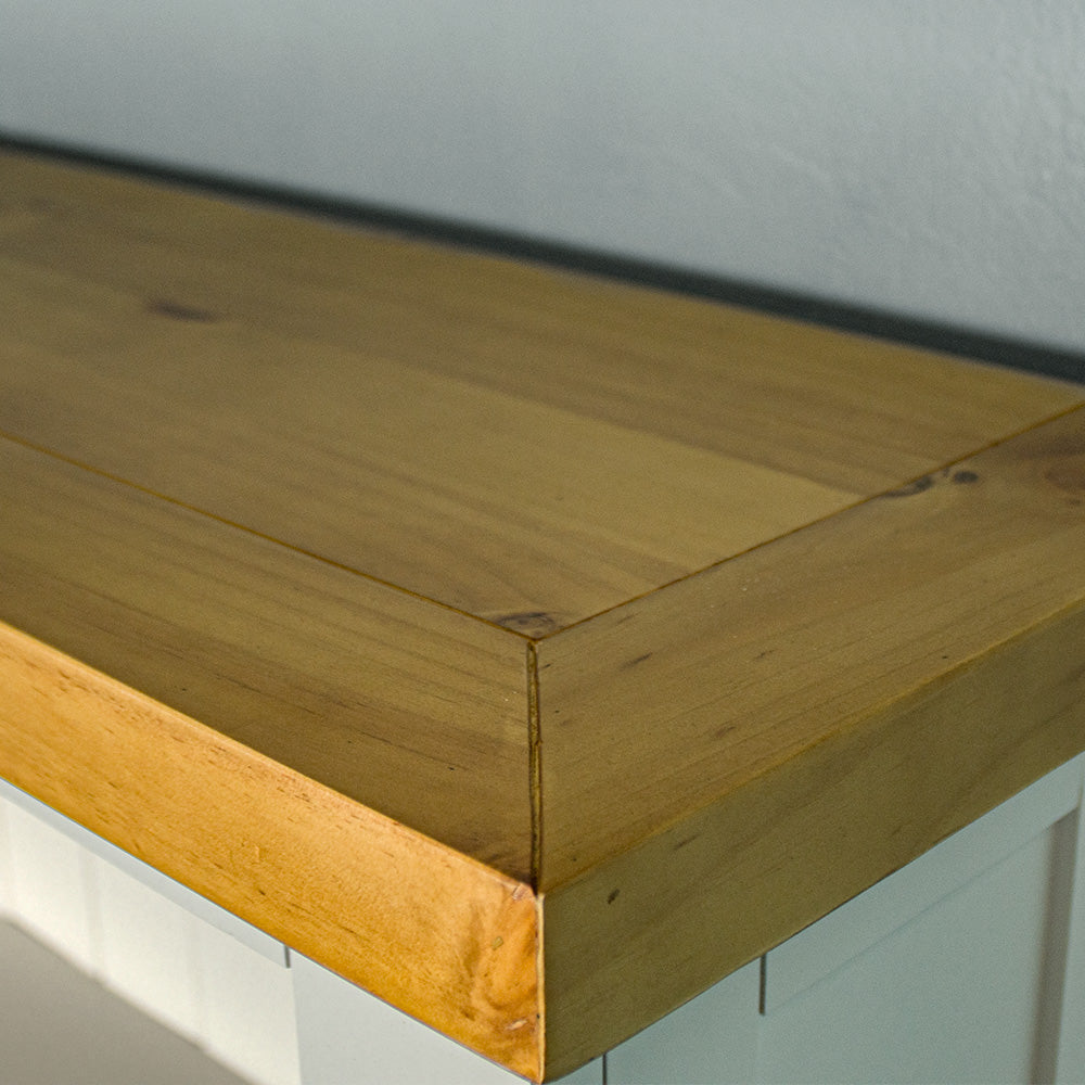 A close up of the top of the Felixstowe Pine Bookcase, showing the wood grain and colour.