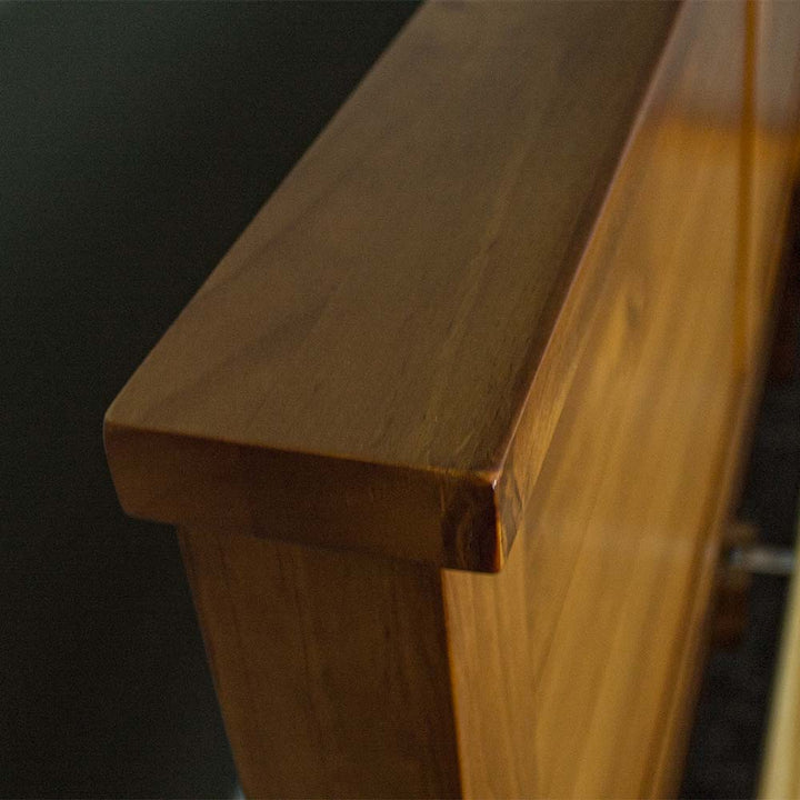 A close up of the top of the Alton Rimu-stained NZ Pine Queen Bed Frame, showing the rimu stain and wood grain.