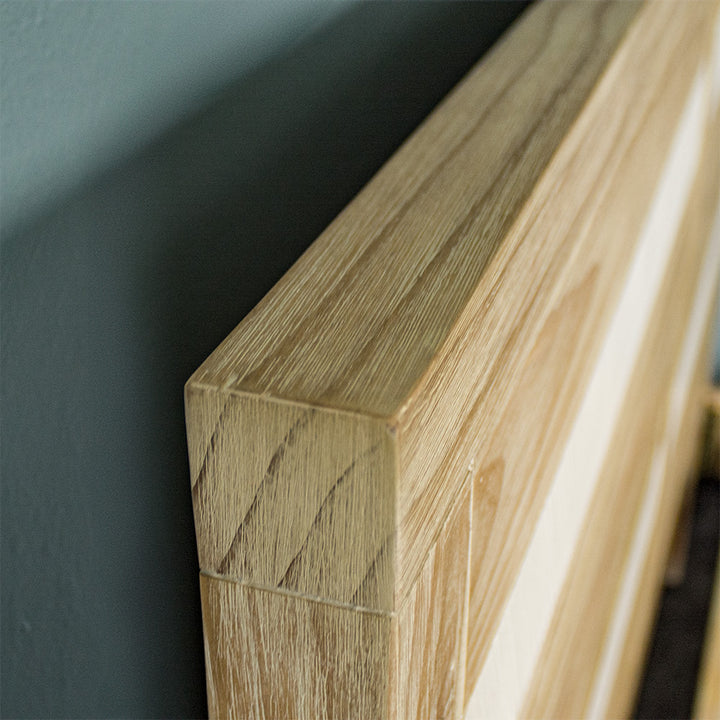 A close up of the top of the Soho Queen Size Slat Bed Frame, showing the wood grain and colour.