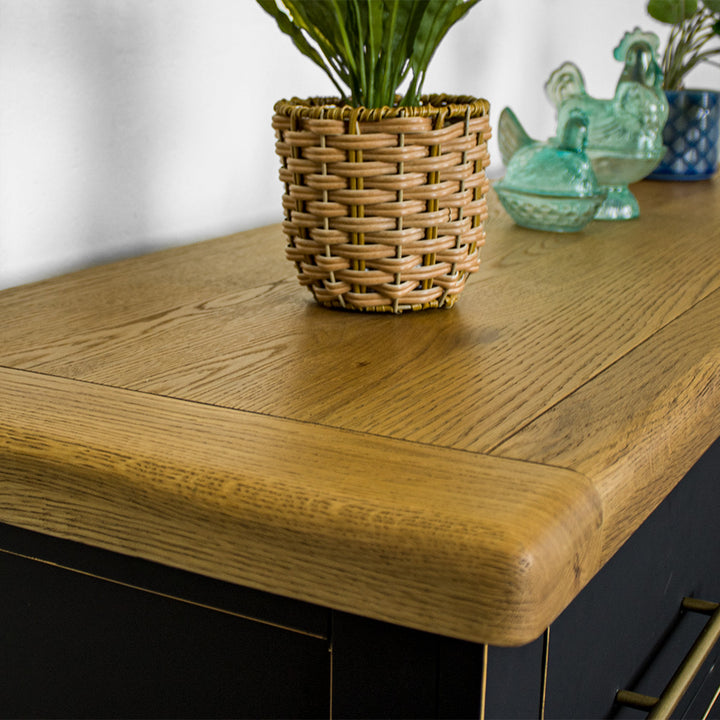 A close up of the top of the Cascais Oak Top 7 Drawer Lowboy (Black), showing the wood grain and colour.